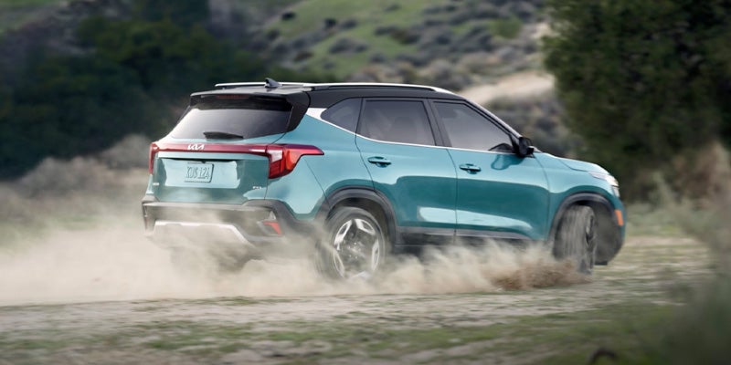 A white SUV parked front of ouse