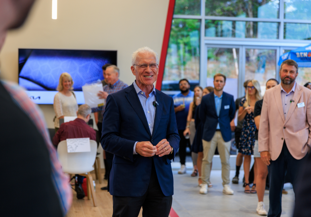 People standing inside the new showroom at Flow Kia of Charlottesville