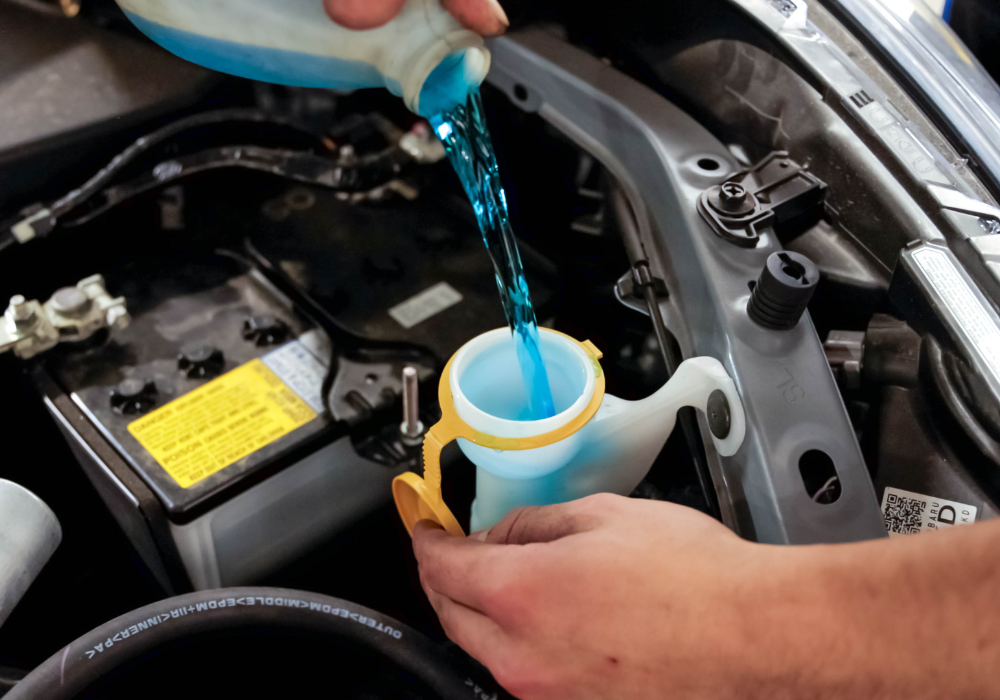 Fluid being replace under the hood of a car